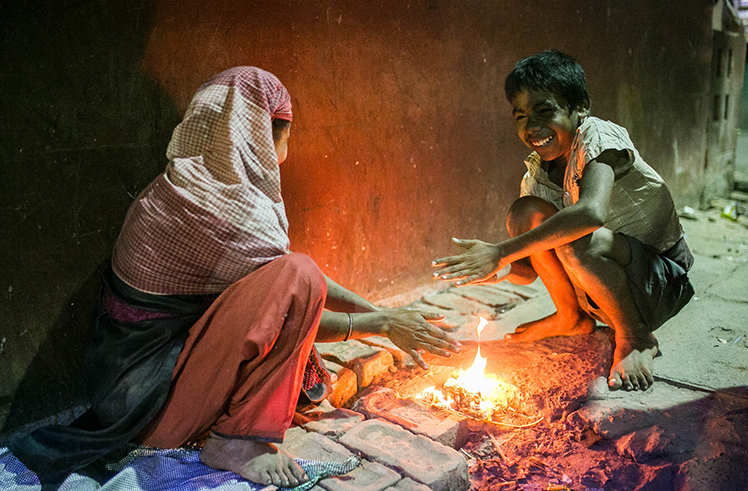 A mother and son trying to stay warm at night