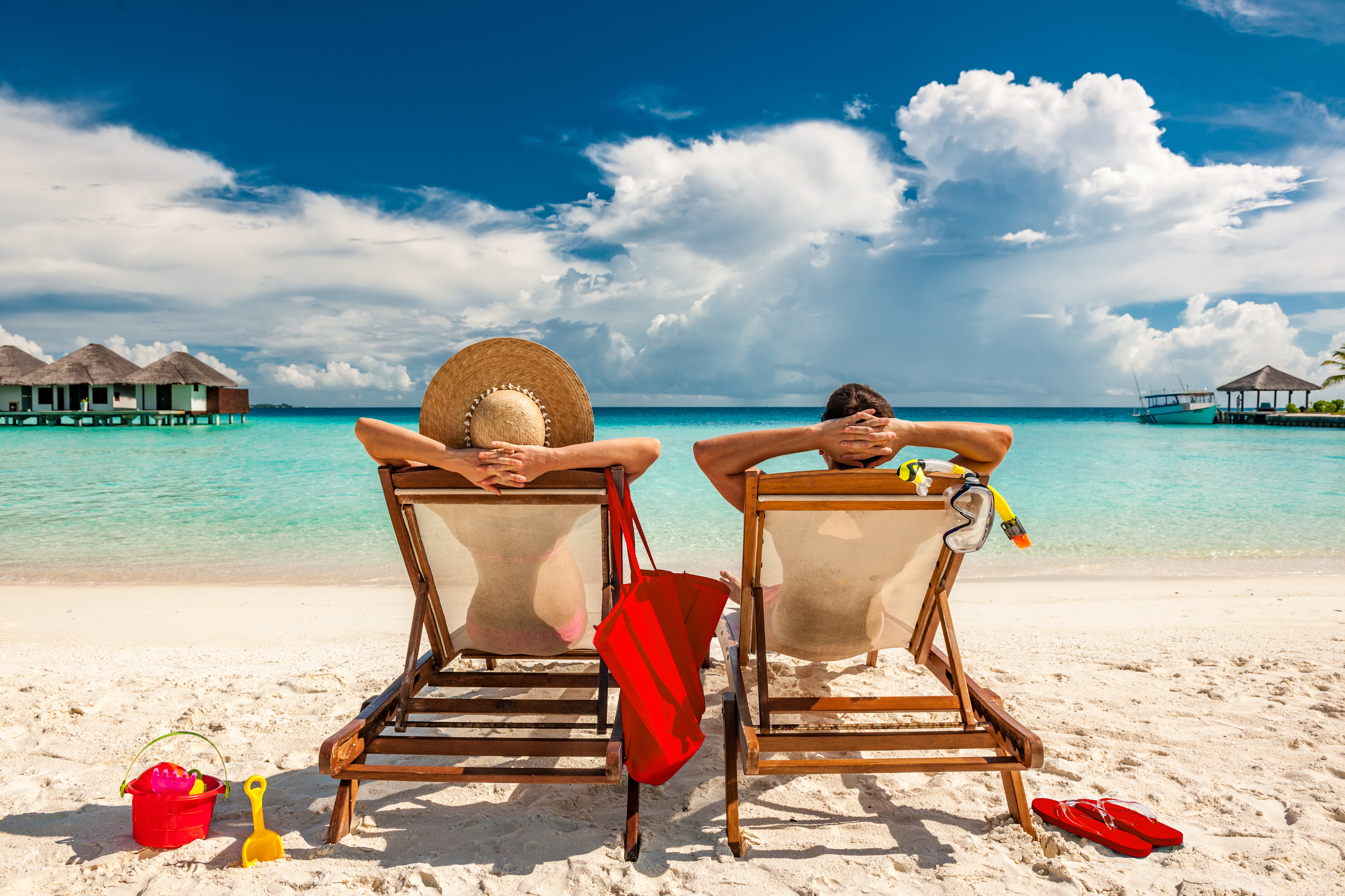 Newlyweds Couple in loungers on a tropical beach