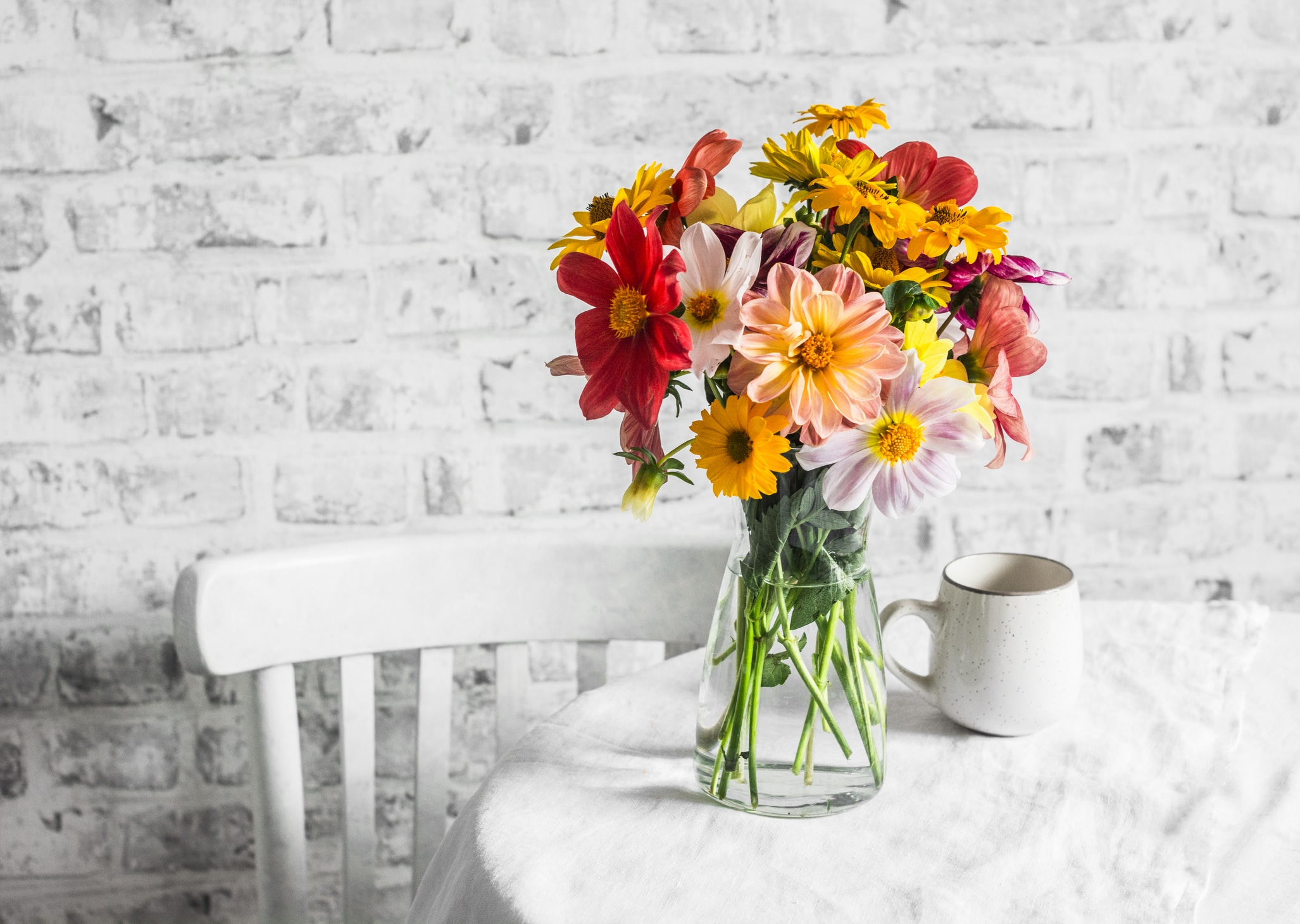 Mixed Flowers with Cup On a Table Indoor