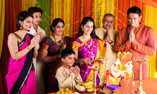 Family praying to Ganesha