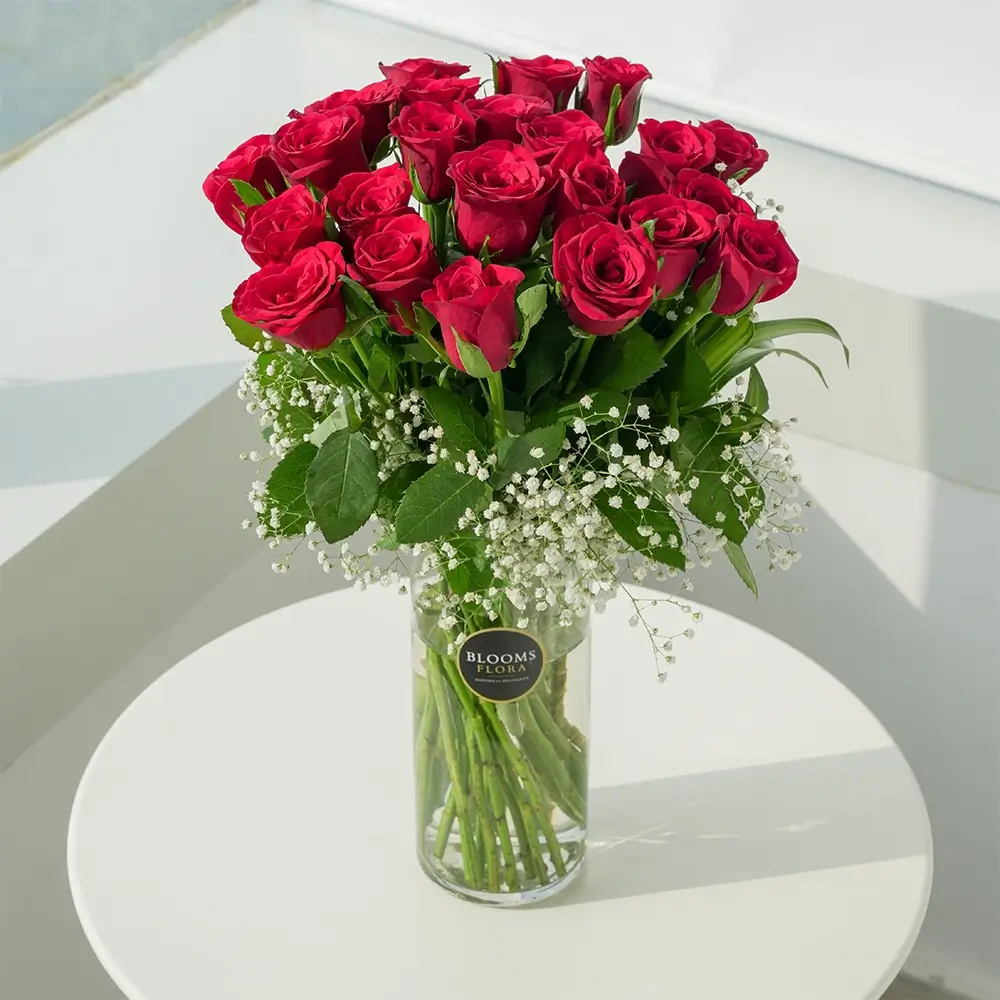 21 red roses and their meanings in a glass vase