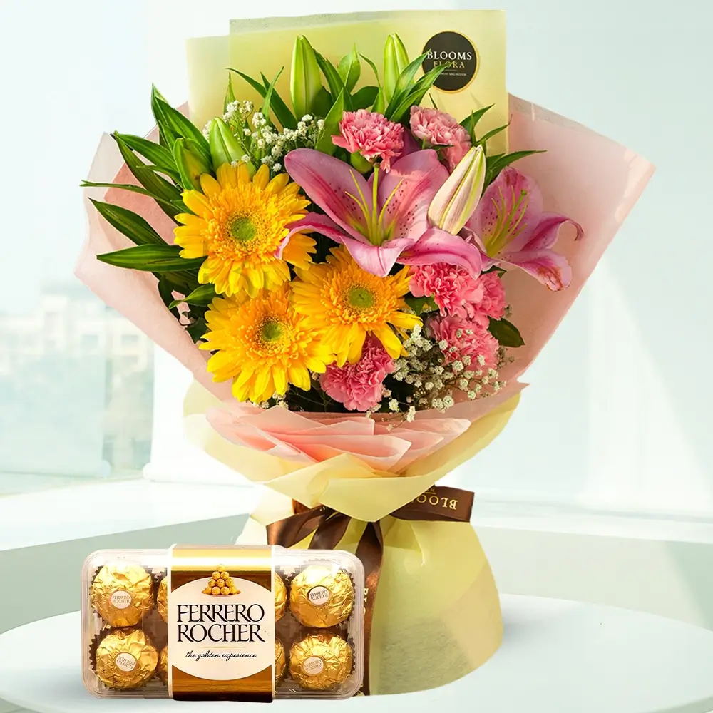 a bouquet of gerberas, lilies and carnations with a box of ferrero rocher chocolates