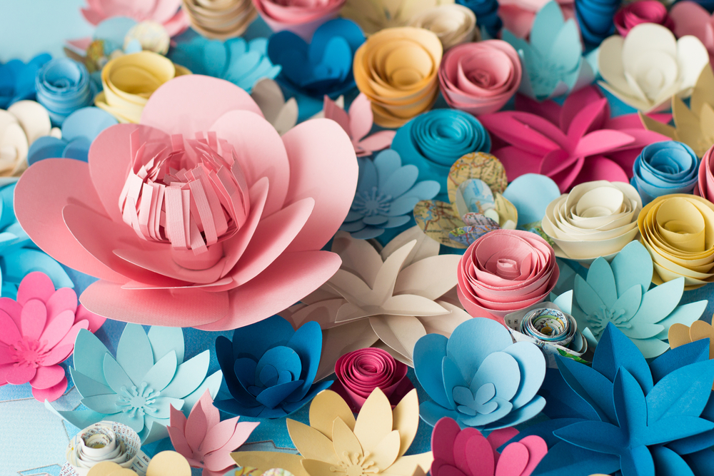a bunch of paper flowers arranged on a surface