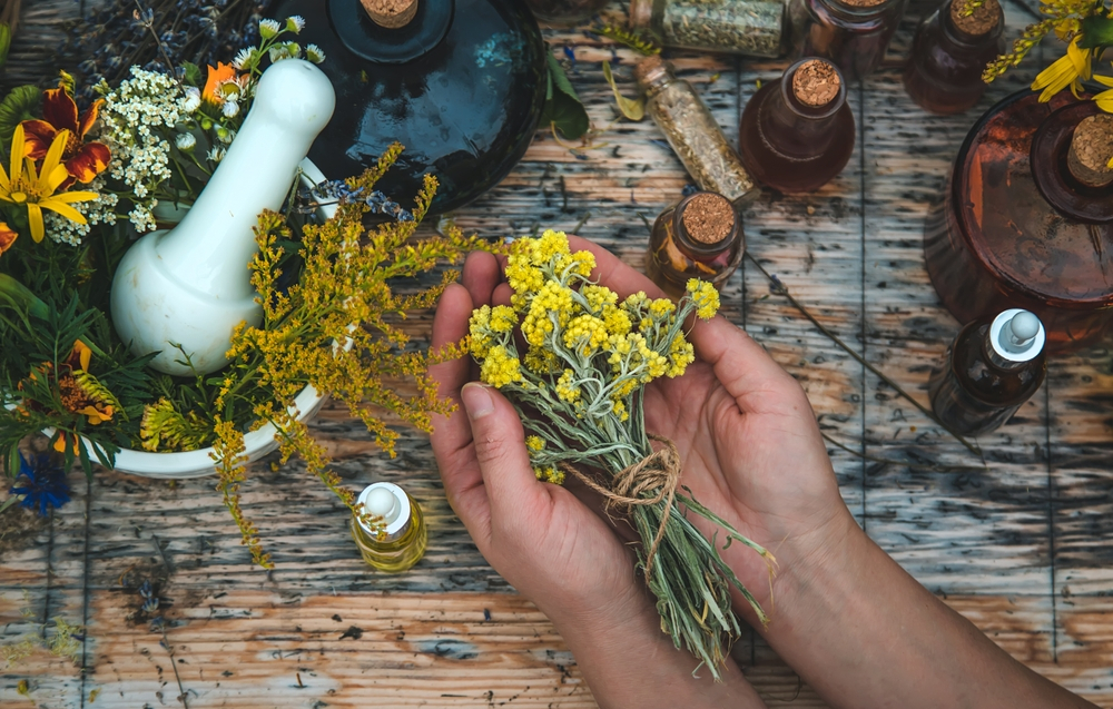 woman with medicinal herbs and tinctures in her hand