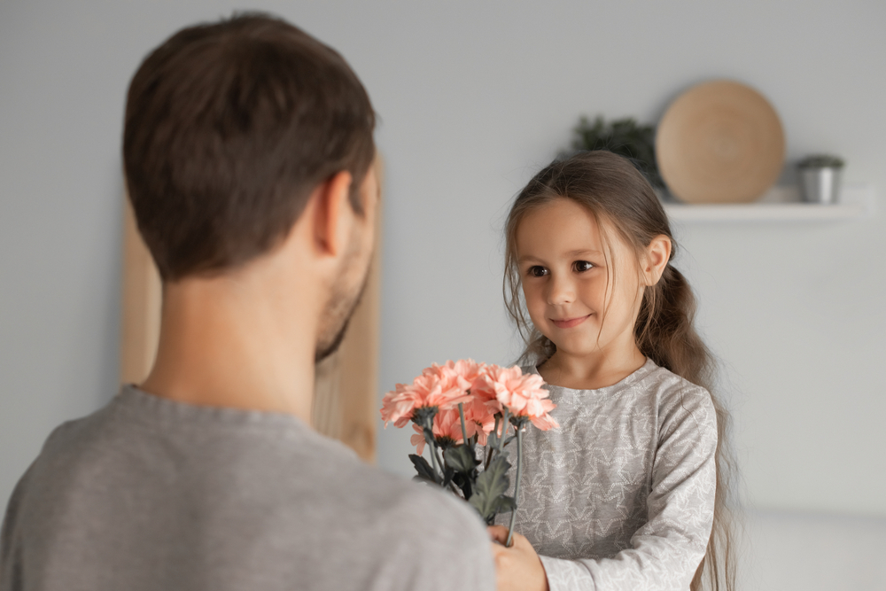 Daughter Giving Flower To His Father