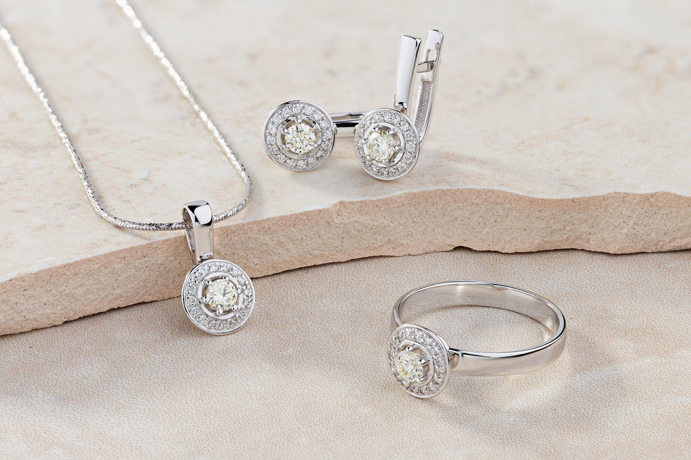 a set of white gold ring, necklace and earrings