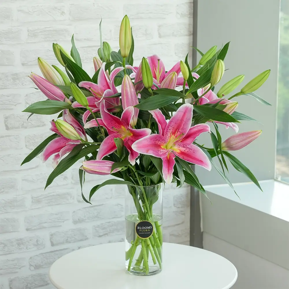 pink lilies in a glass vase