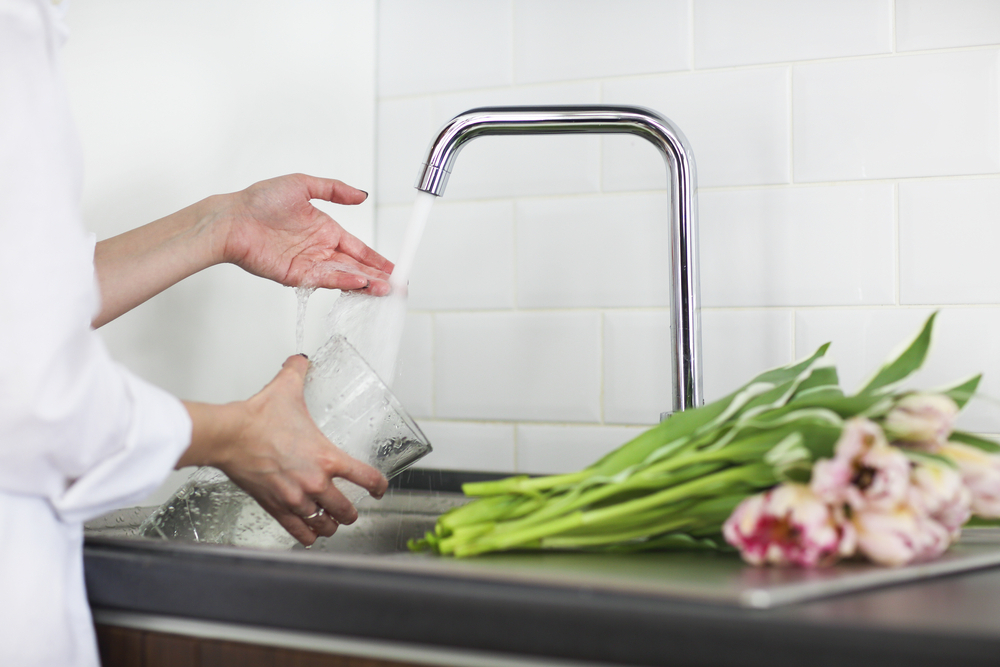 tips to take care of flowers - young woman rinsing cutting flowers pouring